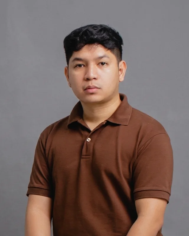 Paul Prado Pacardo, portrait, brown polo shirt on a grey background